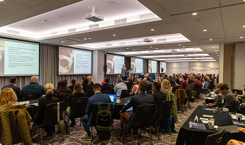 Conference room filled with lawyers and attorneys watching a presentation